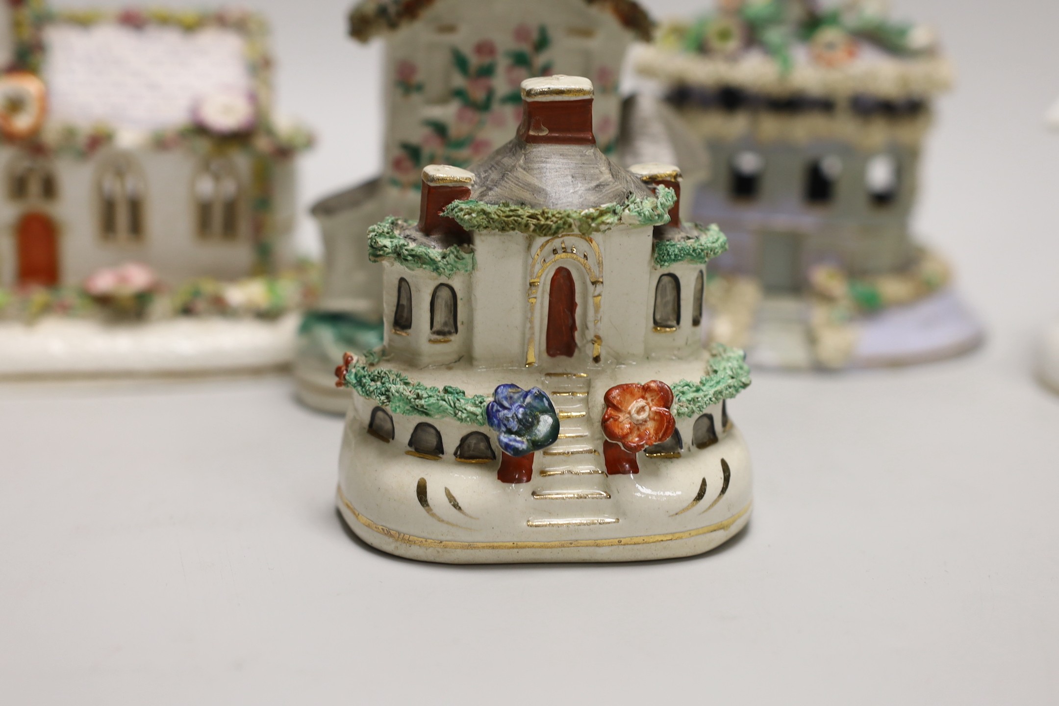 Five Staffordshire porcelain or pottery cottage or church pastille burners and a similar cottage money box, Tallest 14.5cm